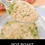 A spoonful of Pot Roast Seasoning recipe mix is held over a bowl filled with the same savory seasoning blend.