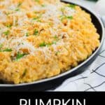A plate of creamy Pumpkin Risotto, garnished with grated cheese and herbs, sits atop a white checkered cloth.