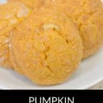 Three Pumpkin Snickerdoodle Cookies rest on a white plate, their golden, textured surfaces capturing the irresistible appeal of this classic fall treat.