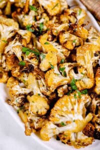A white serving bowl of the roasted spicy cauliflower.