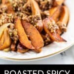 A plate of Roasted Spicy Sweet Potatoes wedges topped with a chunky pecan and herb mixture, with the text "Roasted Spicy Sweet Potatoes" below.