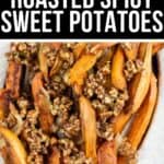 A plate of Roasted Spicy Sweet Potatoes fries topped with a finely chopped spicy nut and herb mixture.