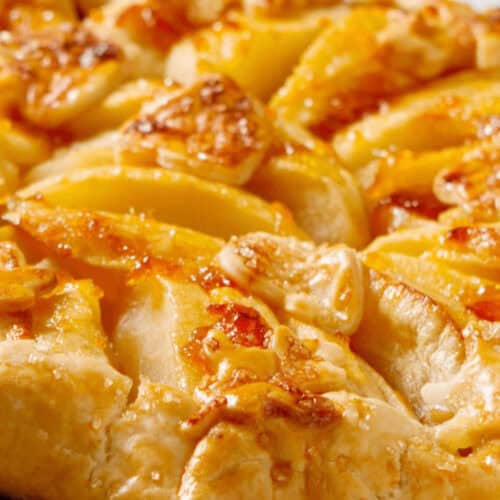 A side view of a rustic apple tart.