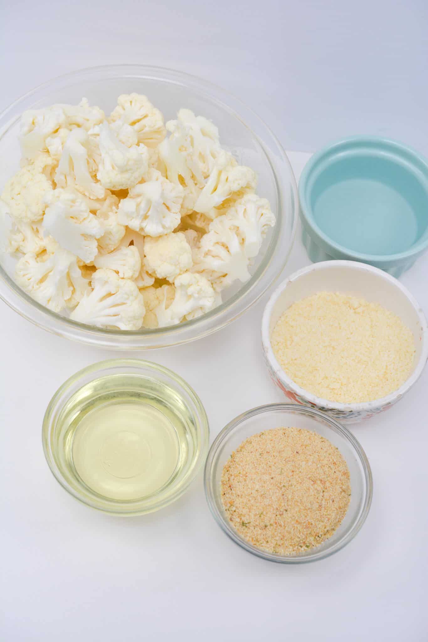 Cauliflower florets, seasoning, cheese and oil.