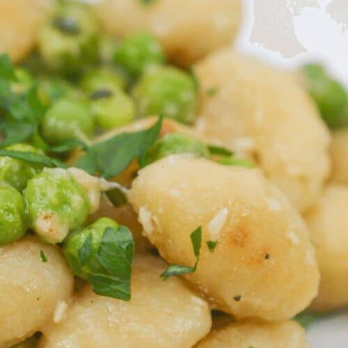 A closeup on the skillet gnocchi and peas.