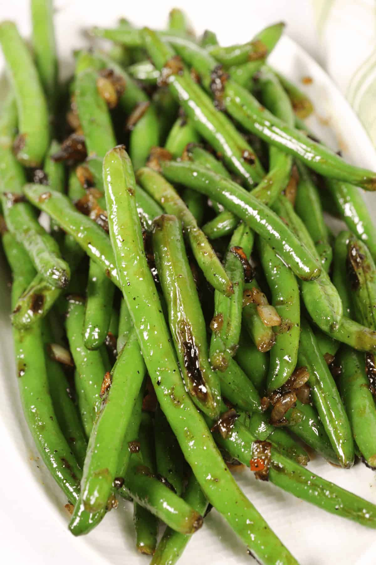 A plate of spicy green beans sautéed with caramelized onions.
