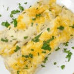 sour cream enchilada sauce on top of the chicken enchilada.