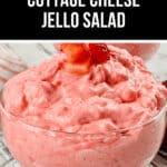 A glass bowl brimming with Cottage Cheese Jello Salad, featuring a luscious pink strawberry hue and crowned with a fresh strawberry slice.