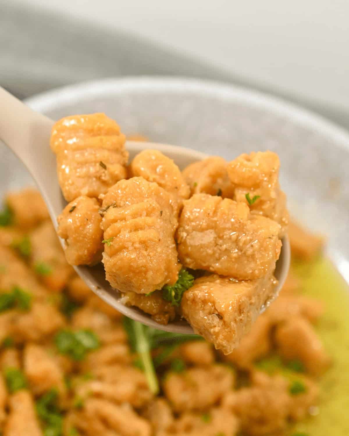 A  spoon in a platter of the finished dish.