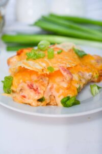 A white plate with a serving of the tex mex casserole with ground beef.