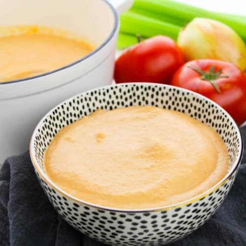 Ttomato bisque in a stoneware bowl.