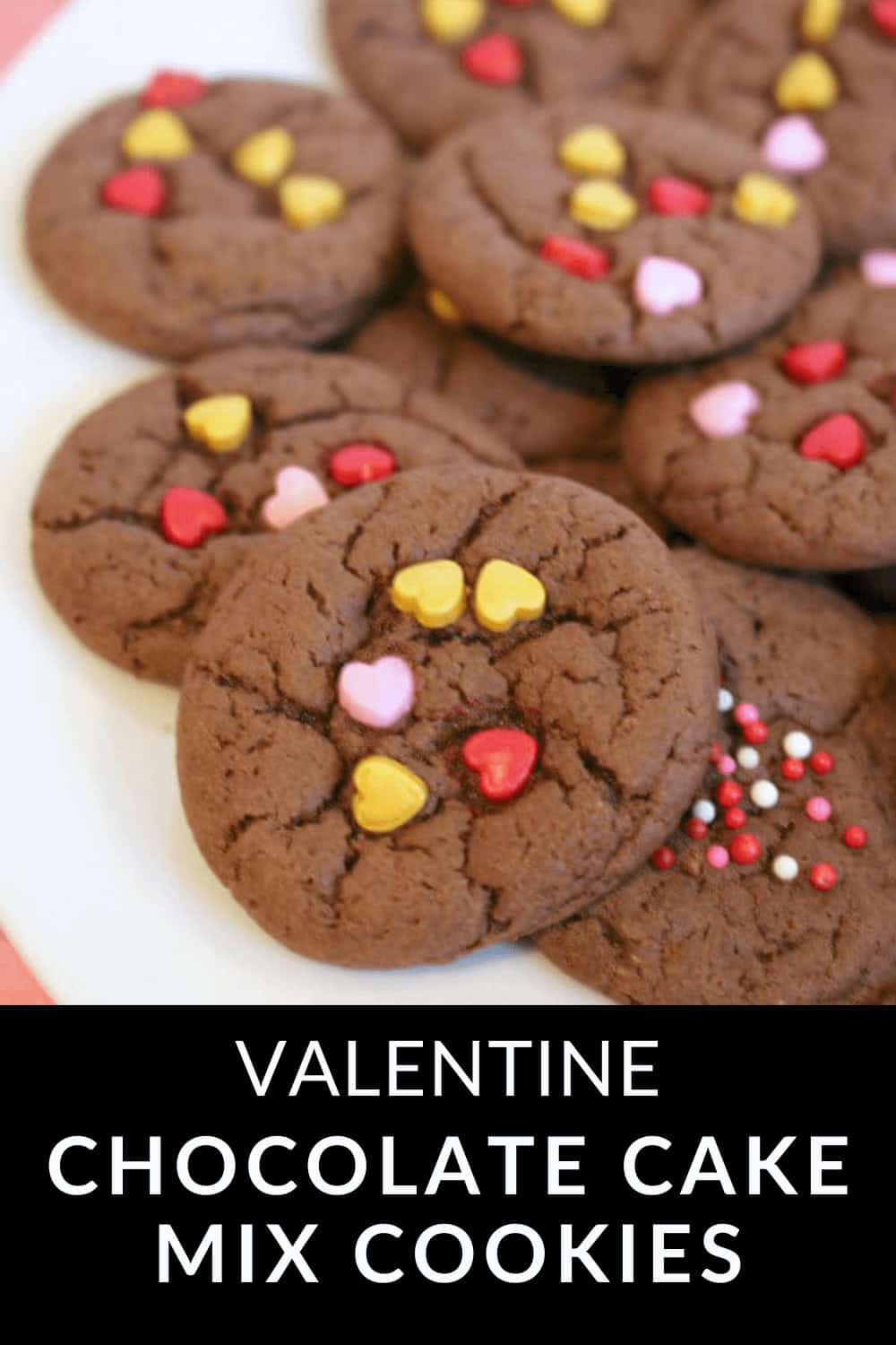 A plate of delicious chocolate cake mix cookies adorned with heart-shaped and round sprinkles, perfectly labeled for Valentine’s Day.