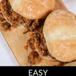 Two sloppy joes on a wooden board, filled with a savory ground meat and vegetable mixture. Text overlay reads "Easy Wimpies Sloppy Joes.