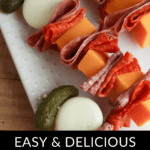 Charcuterie Skewers with cheese cubes, folded deli meat, pickles, and small mozzarella balls on a white tray, labeled "Easy & Delicious Charcuterie Skewers.