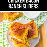 A plate of juicy Chicken Bacon Ranch Sliders stacked on a wooden board. The text "Party Favorite Chicken Bacon Ranch Sliders" is displayed at the top.