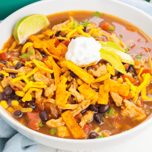 A white bowl of rotisserie chicken tortilla soup.