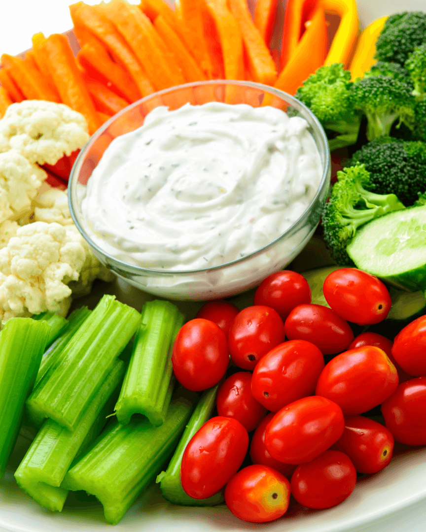 A plate of vegetables with Sour Cream and Ranch Dip.